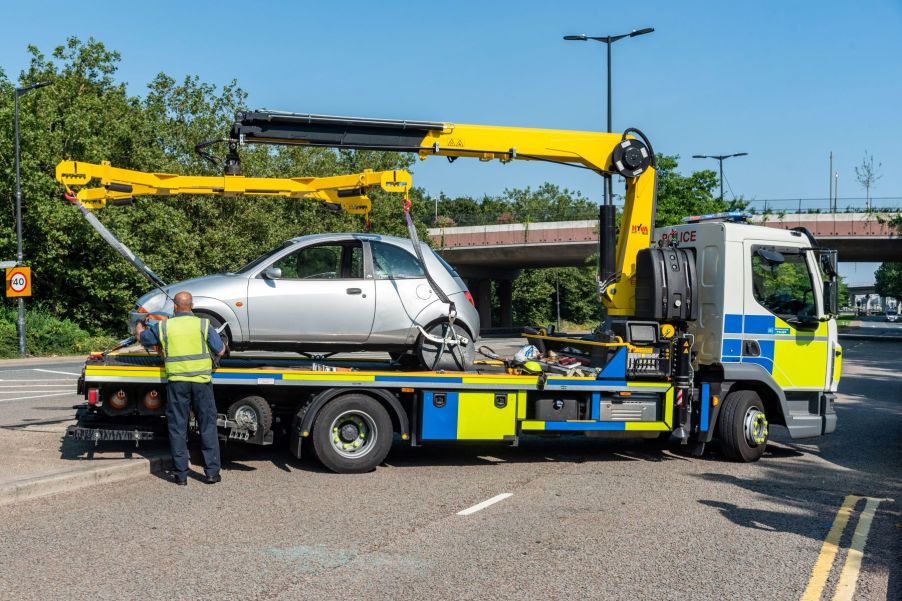 Police repossessing and securing a car in London, United Kingdom (U.K.)