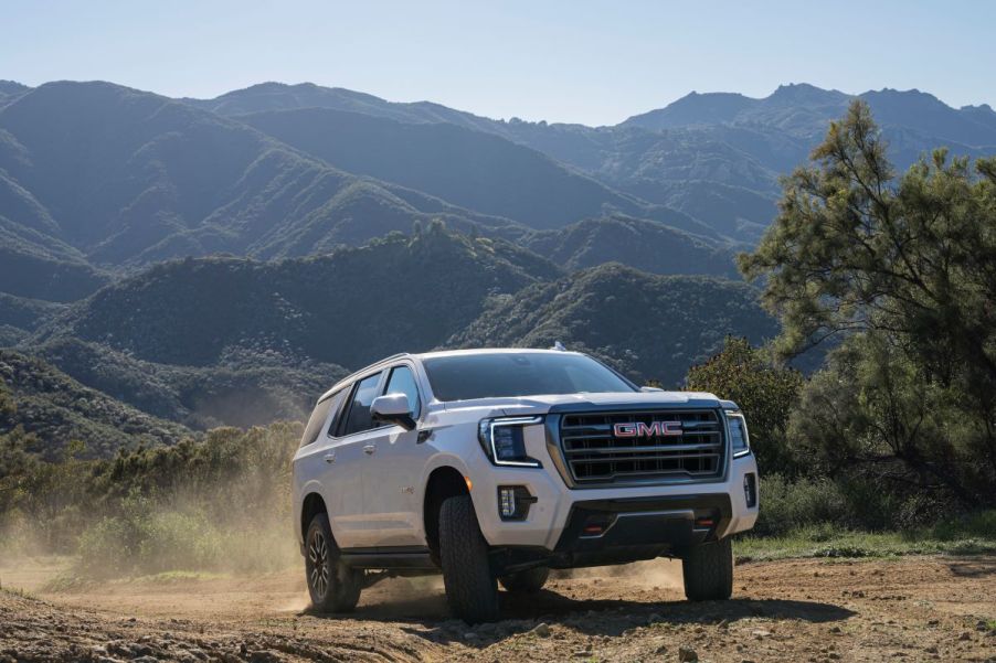 A white 2022 GMC Yukon AT4 in an outdoor mountainous environment.