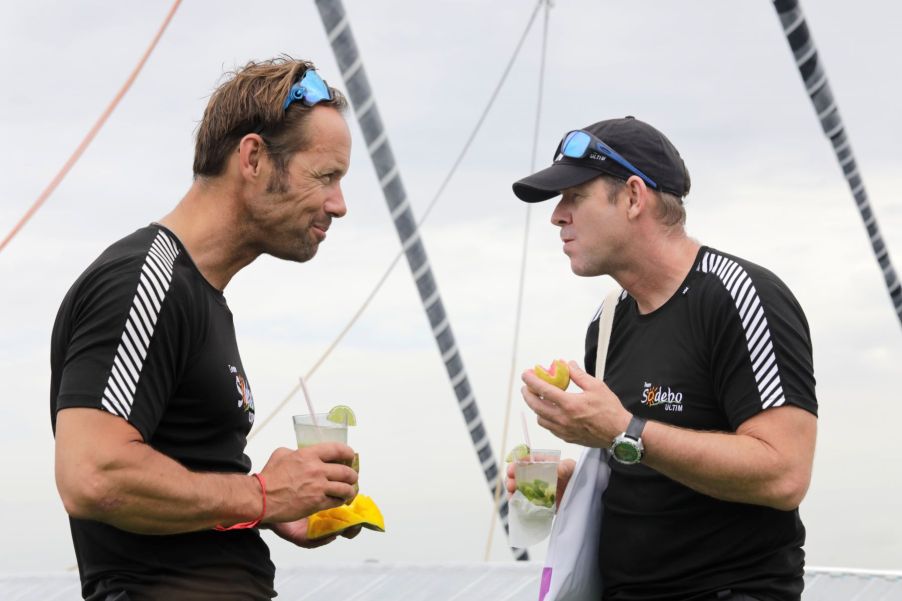 French yacht racers Thomas Coville and Jean-Luc Nelias celebrating with alcoholic drinks after winning a race in Salvador, Brazil