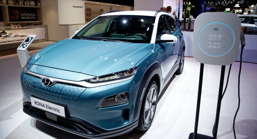 A blue Hyundai Kona Electric is on display.