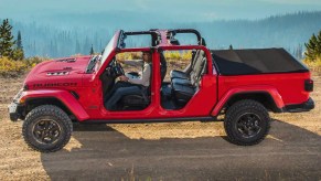 Red Jeep Gladiator on a dirt road