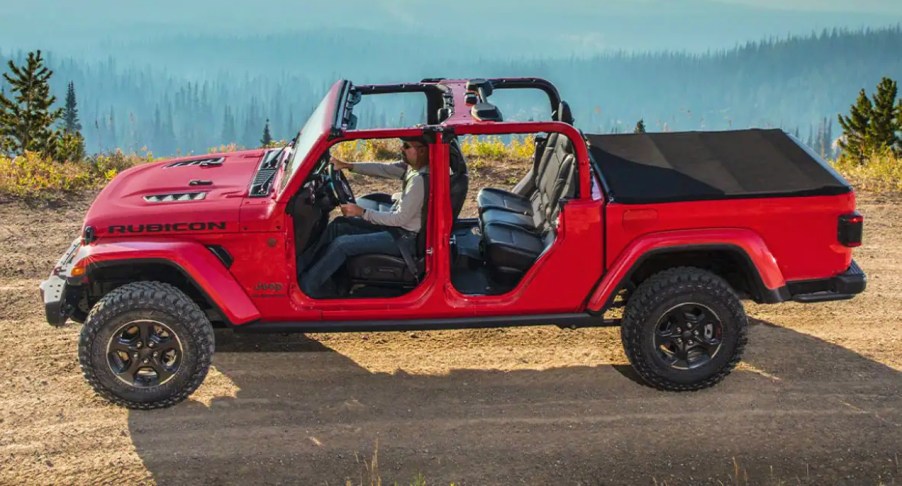 Red Jeep Gladiator on a dirt road