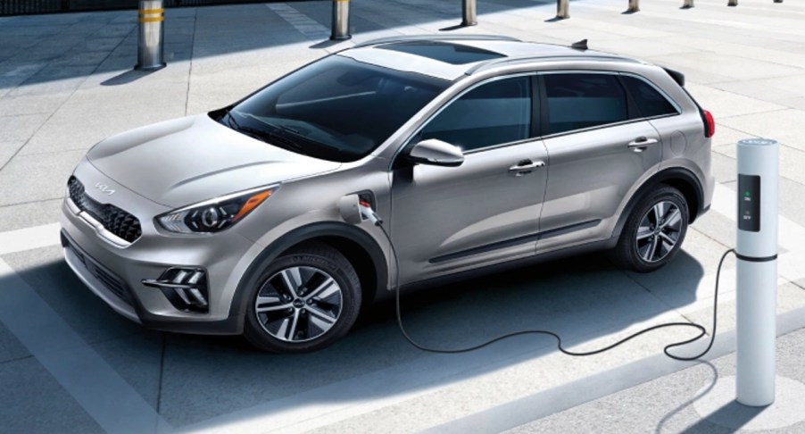 A gray Kia Niro PHEV is charging.