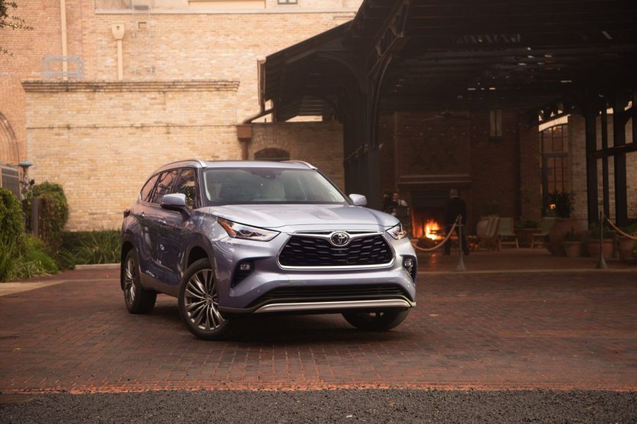 Moon Dust 2022 Toyota Highlander parked near a brick building