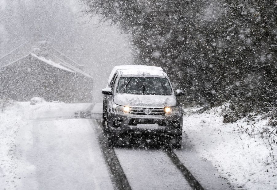 A vehicle driving in the snow, potentially AWD or 4WD.