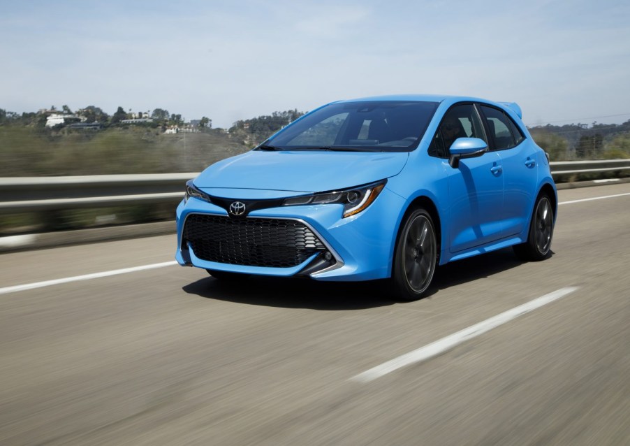 Blue 2022 Toyota Corolla Hatchback XSE Driving down the road shot from front