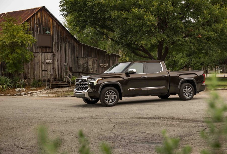 A dark colored 2022 Toyota Tundra parked outside of a building.