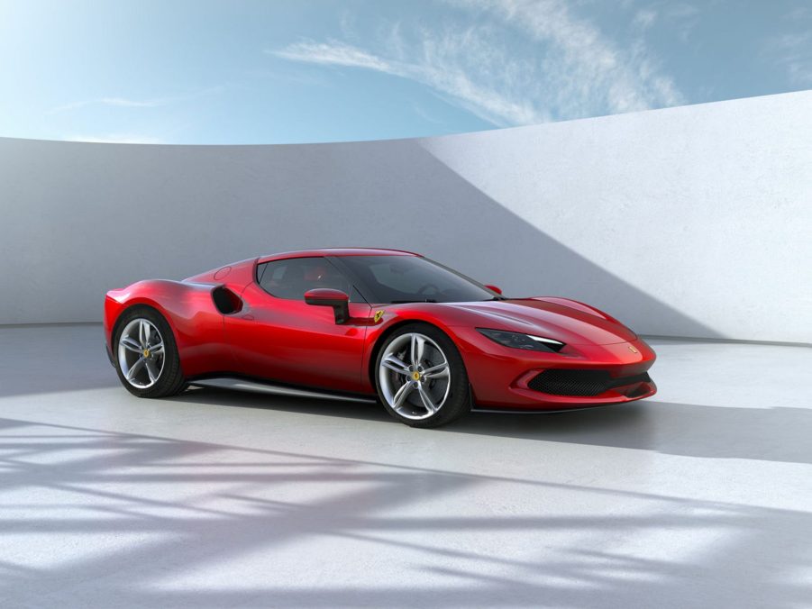 A red 2023 Ferrari 296 GTB in a white-walled open space