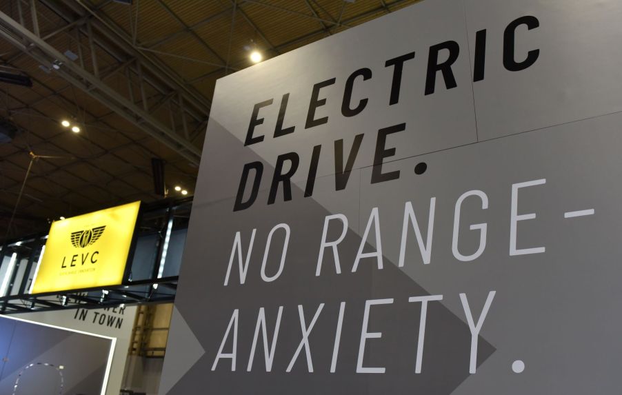 An EV sign promoting electric driving range seen during the Commercial Vehicle Show in Birmingham, England