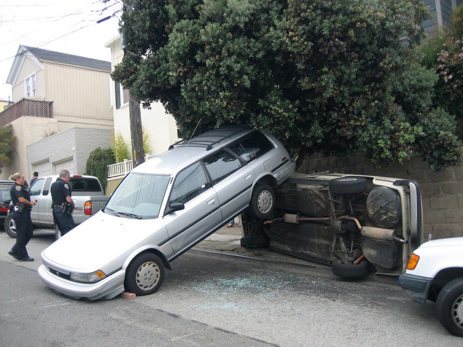 Subaru backover accident hit parked car hard enough to make it roll over in California