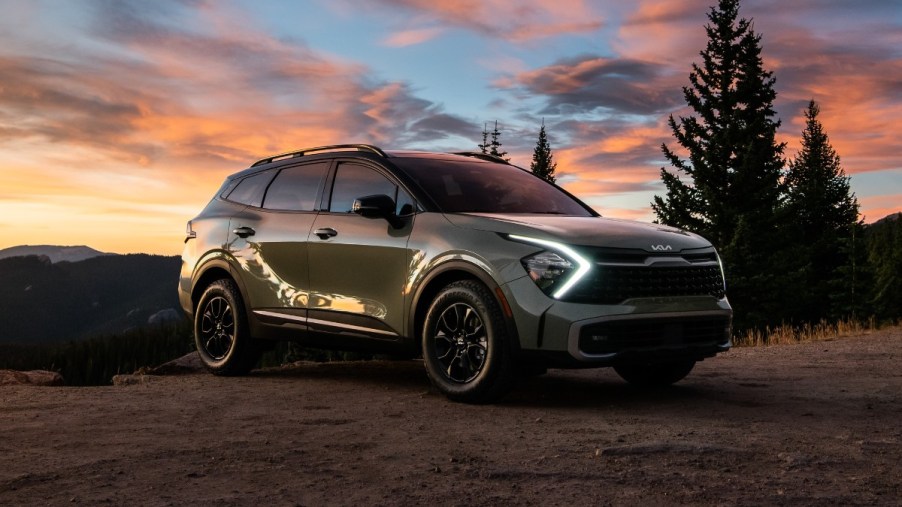 Green 2023 Kia Sportage parked on a mountain