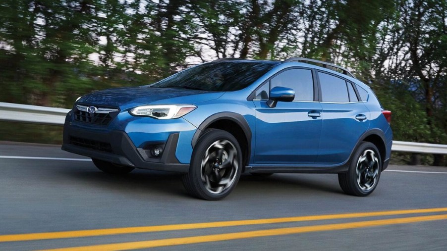 Horizon Blue Pearl 2022 Subaru Crosstrek driving by a forest