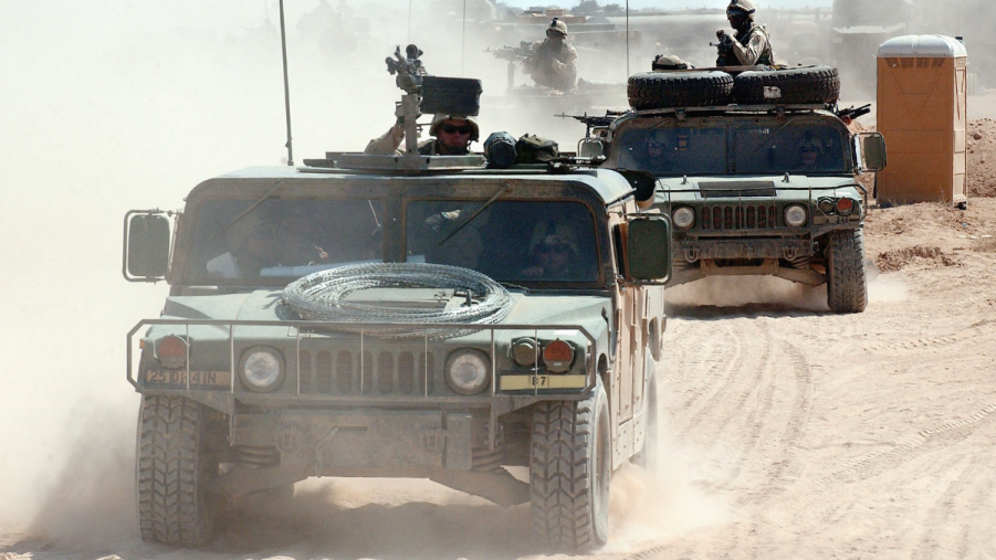 Humvees driving on a sandy road, highlighting SUVs in Ukraine military