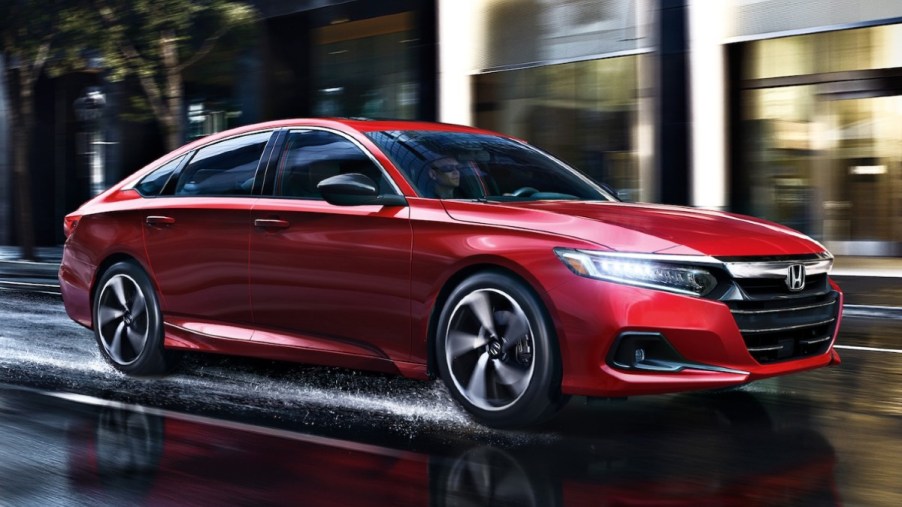 San Marino Red 2022 Honda Accord driving on a wet road