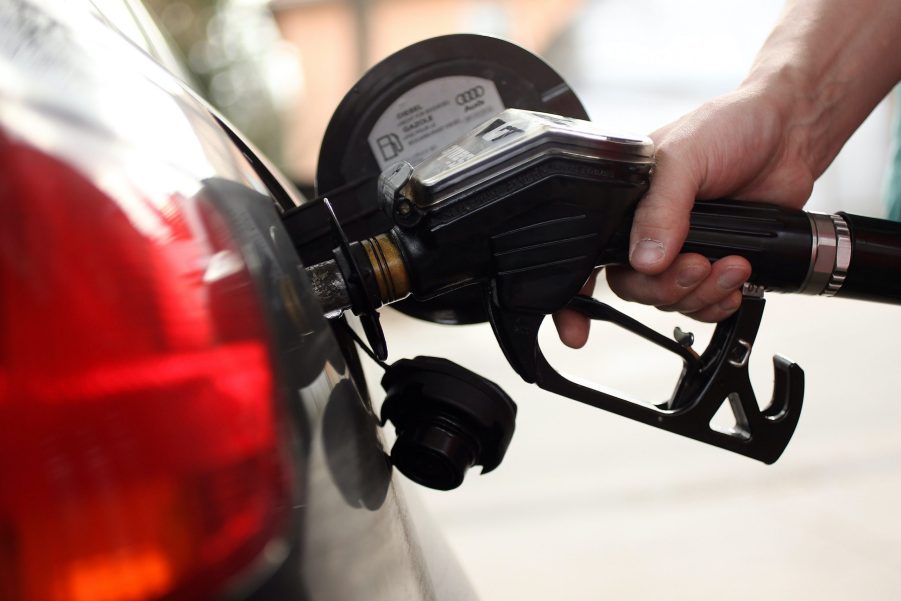 A gas pump fueling a car