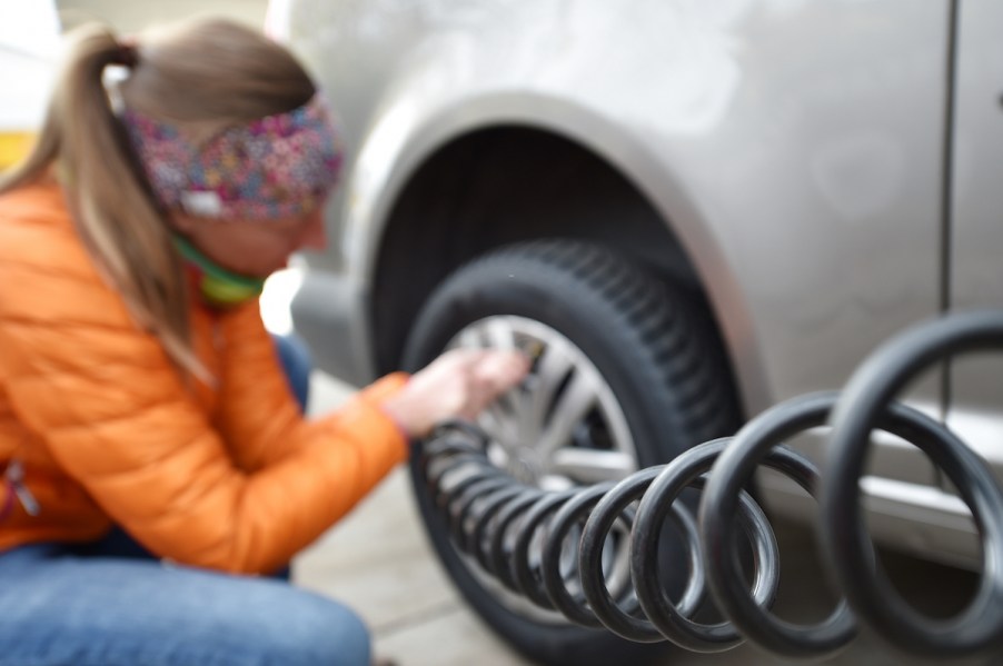 Woman tests air pressure in winter tires