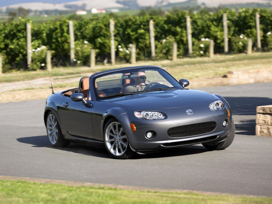 Silver 2006 Mazda Miata Sports Roadster going through a corner