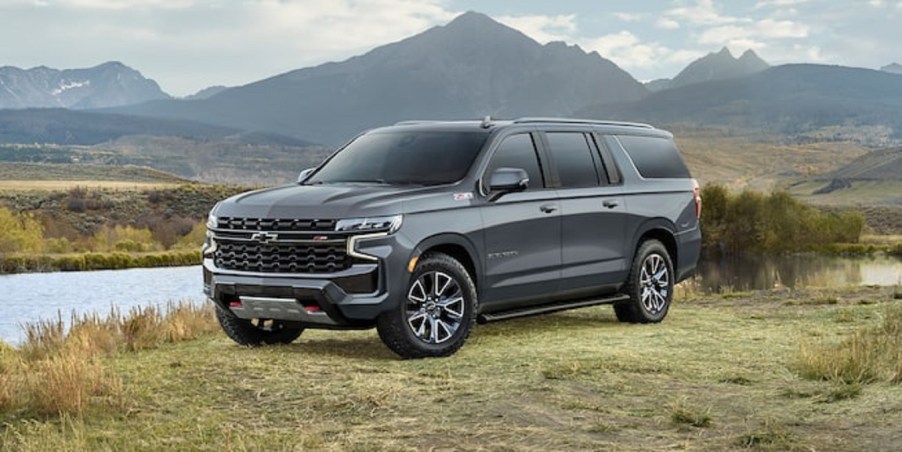 A gray 2022 Chevy Suburban parked in the mountains.