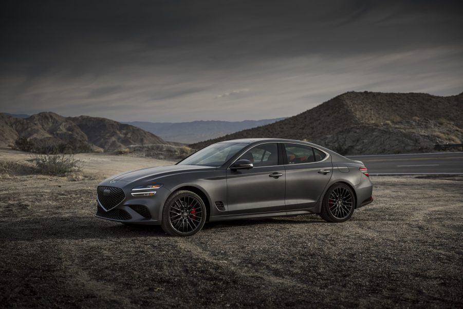 A matte-gray 2022 Genesis G70 on a mountain road