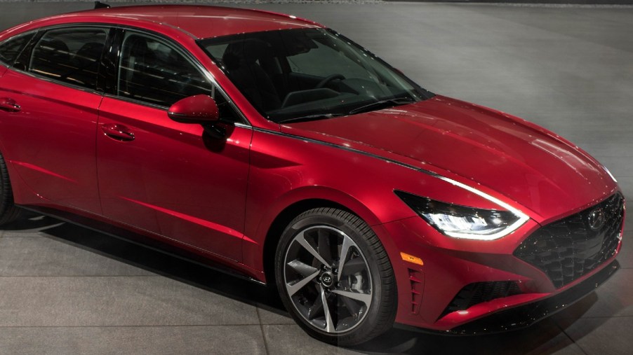 Red 2022 Hyundai Sonata parked at night with LED lighting on in the front