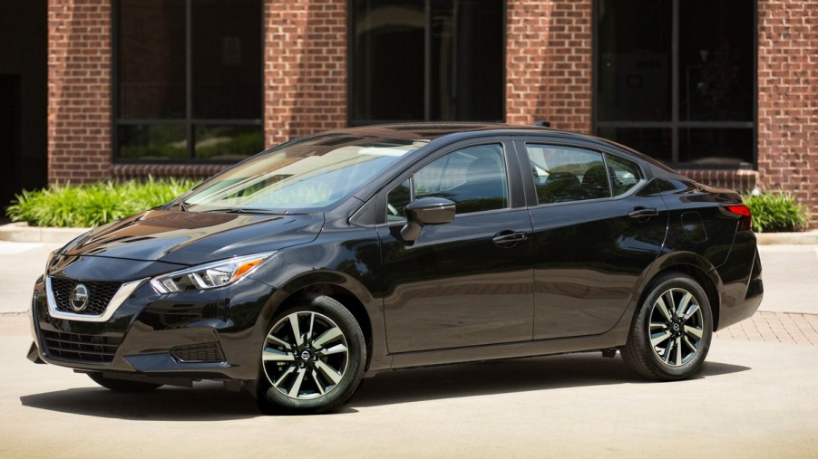 a new black 2022 Nissan Versa is parked to show off its modern and elegant exterior