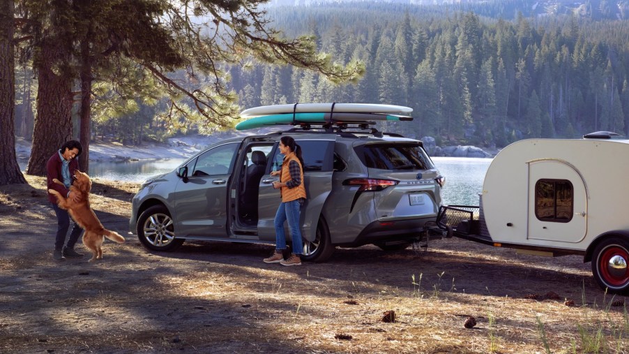 A blue 2022 Toyota Sienna parked next to a river.