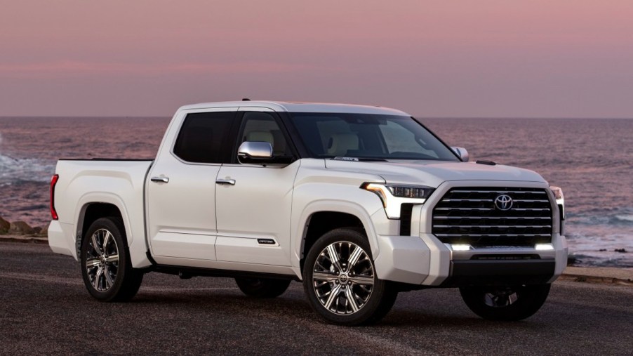 White 2022 Toyota Tundra Capstone Pickup Truck next to the beach during a sunset.