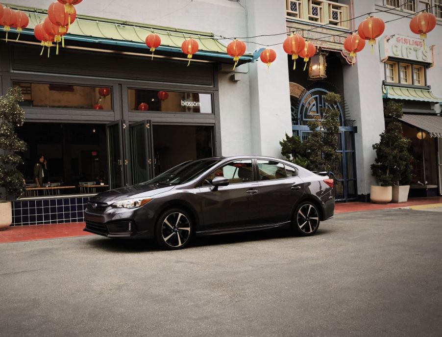 Side view of a black 2022 Subaru Impreza, one of the best and most reliable new cars under $20,000