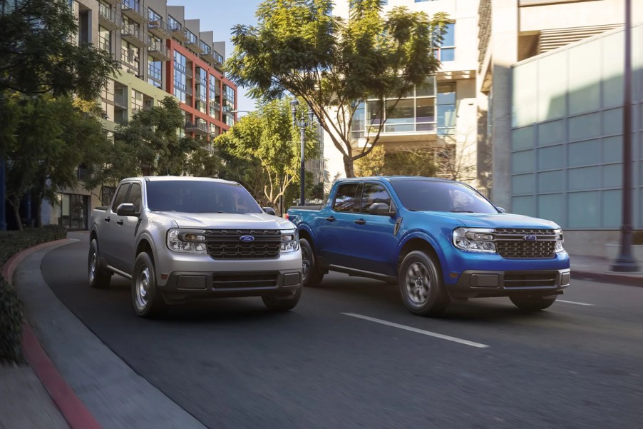 A pair of 2022 Ford Maverick small trucks navigate an urban environment.