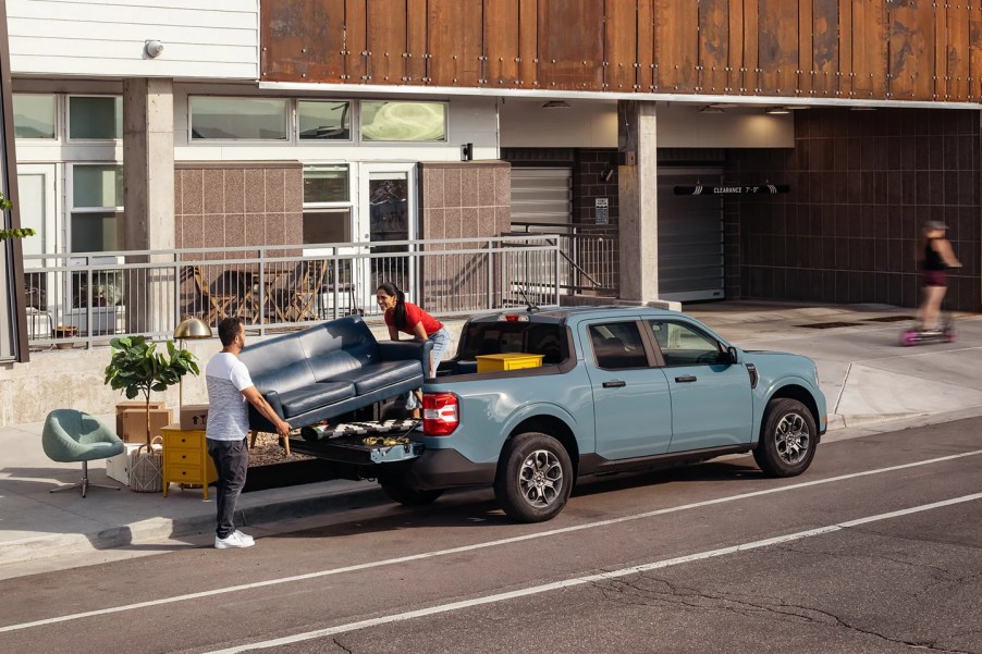 A 2022 Ford Maverick has a couch and some other furniture loaded into its bed.