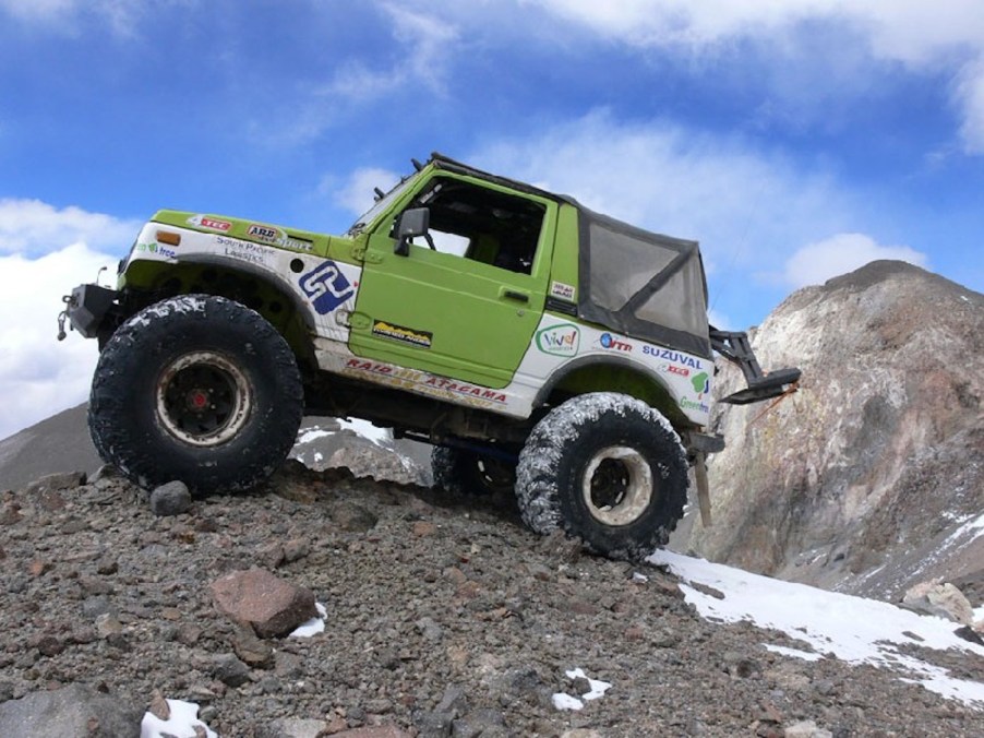 Green 1986 Suzuki Samurai parked atop a mountain in Chile.