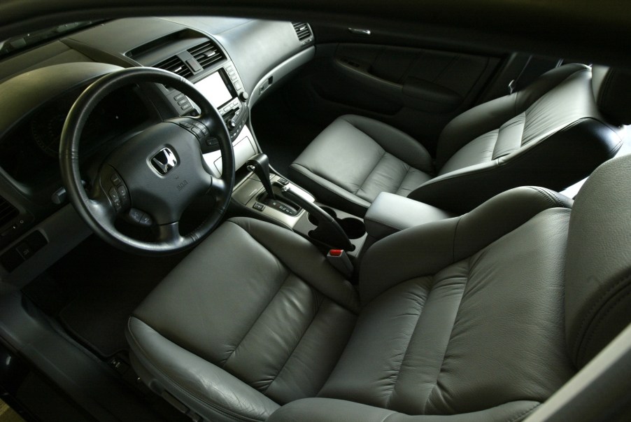 The gray-leather front seats and dashboard of a 2005 7th-gen Honda Accord Hybrid