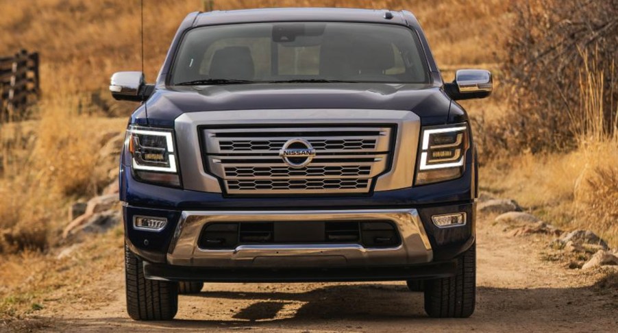 A blue 2022 Nissan Titan pickup truck is parked.