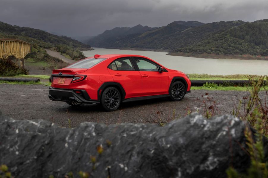 Red 2022 Subaru WRX parked on the side of the road on a dark, foggy day. The 2022 WRX's specs are similar to last year's.