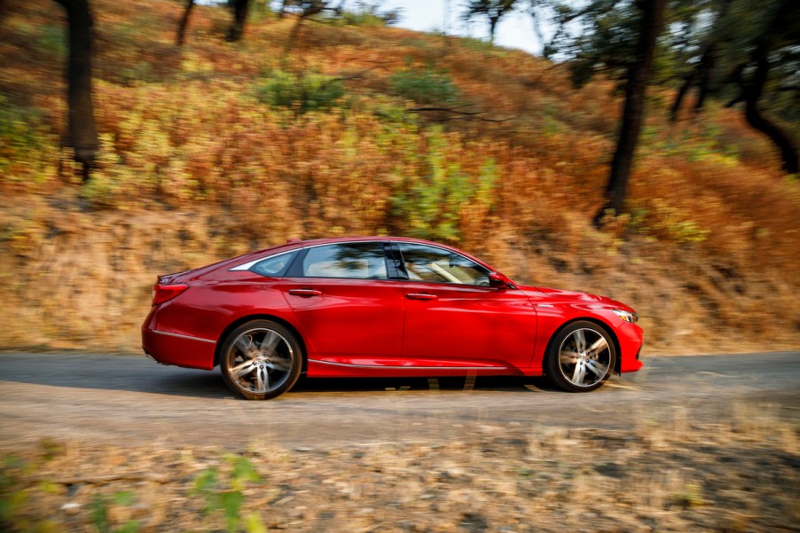 Red 2022 Honda Accord midsize sedan driving on a curved road