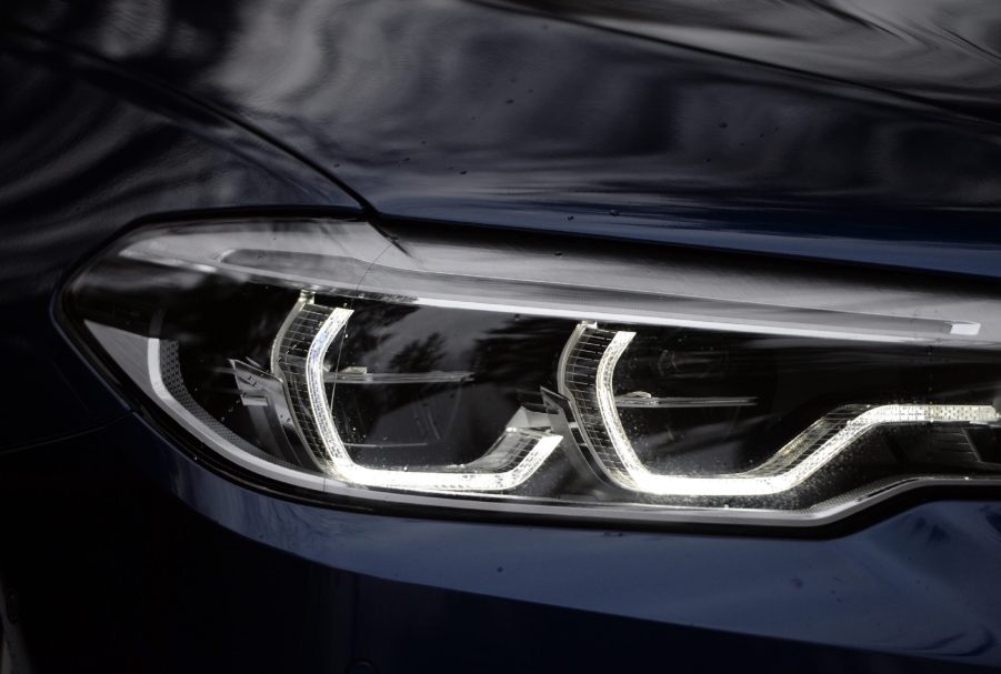 A dark-blue 2018 BMW M550i's full-LED adaptive headlights