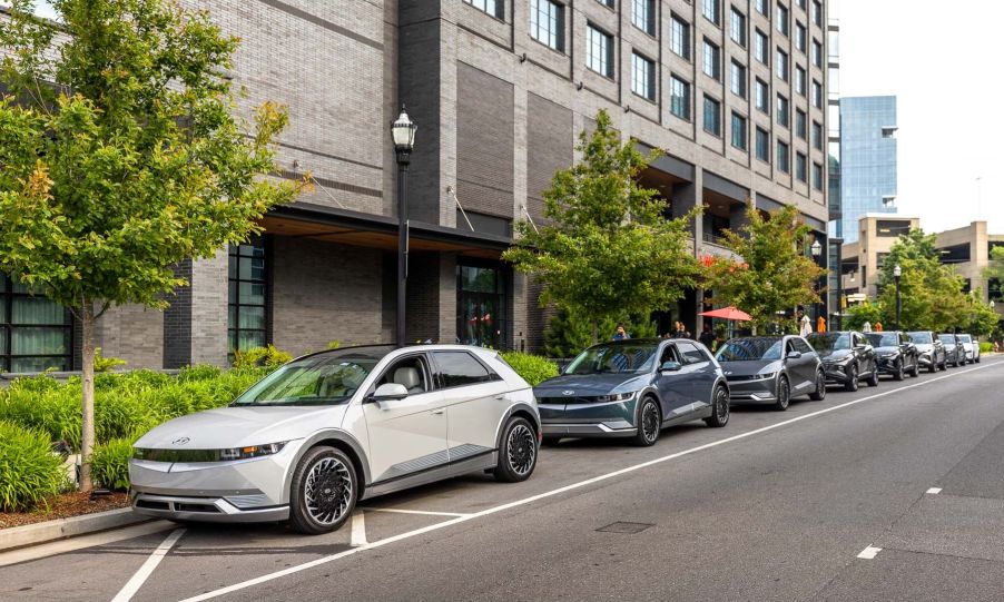 2022 Hyundai Ioniq 5 models parked on the side of a city street near a cafe