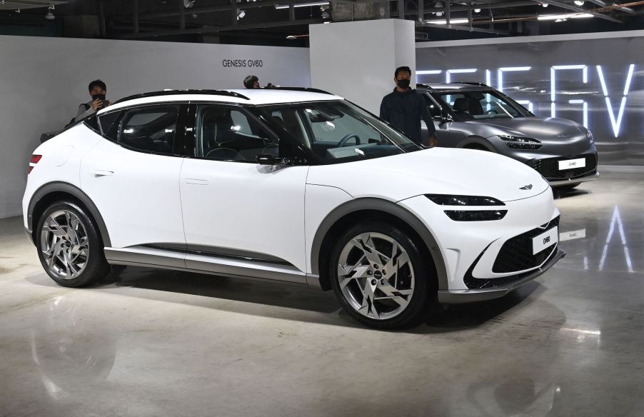 A white Genesis GV60 parked indoors.