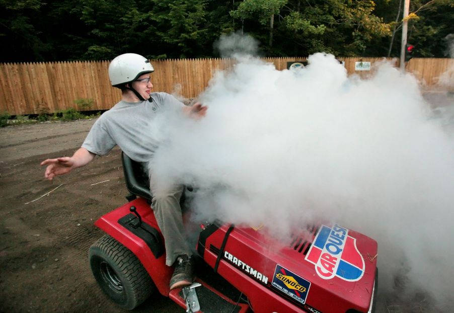 A smoking riding lawn mower during a race at the Saco Pathfinders Snowmobile Club