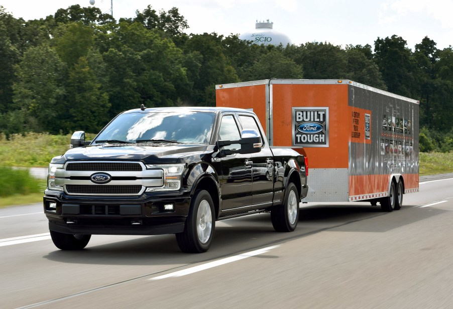 A Black 2018 Ford F-150 towing a Ford trailer. This is one of the best 2018 pickup trucks to buy