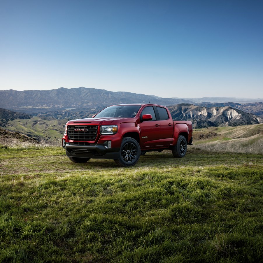 A red 2022 GMC Canyon on green pastures