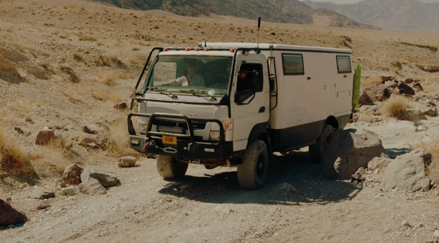 EarthCruiser Adventure action shot of a rig plowing through the sand