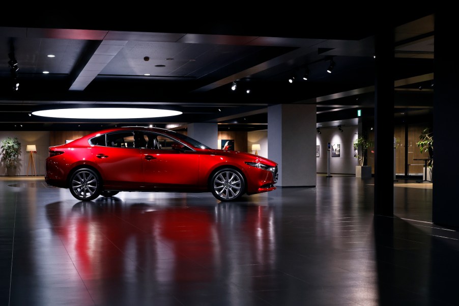 A red 2022 Mazda 3 parked indoors.