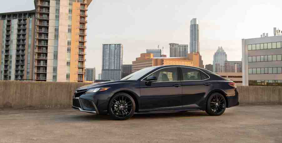 A Black 2022 Toyota Camry parked in an industrial setting