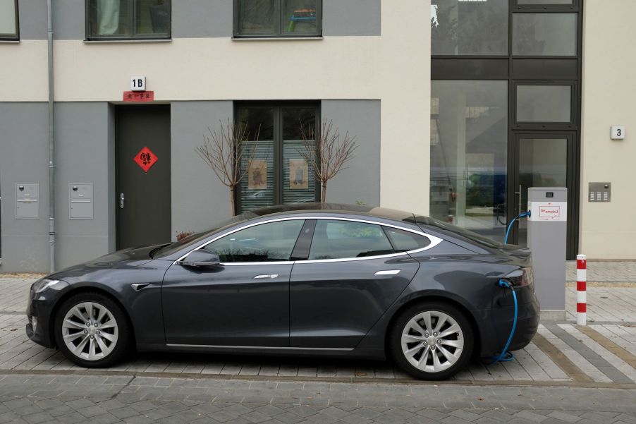 A Tesla Model S electric (EV) luxury full-size sedan charging at a public station in Berlin, Germany