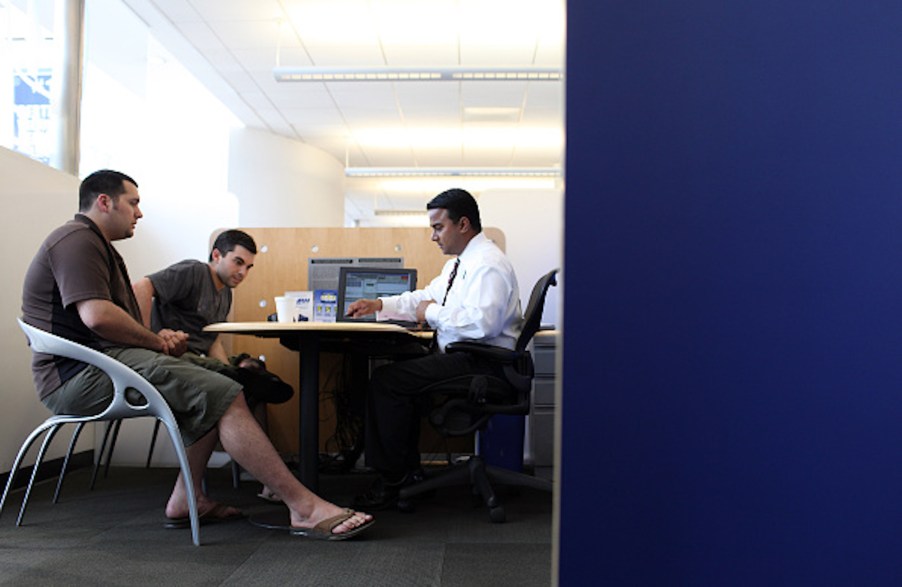 A deal being made, potential for a leased car, inside a dealership.