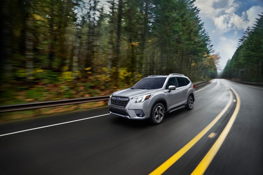 A silver 2022 Subaru Forester Compact SUV driving