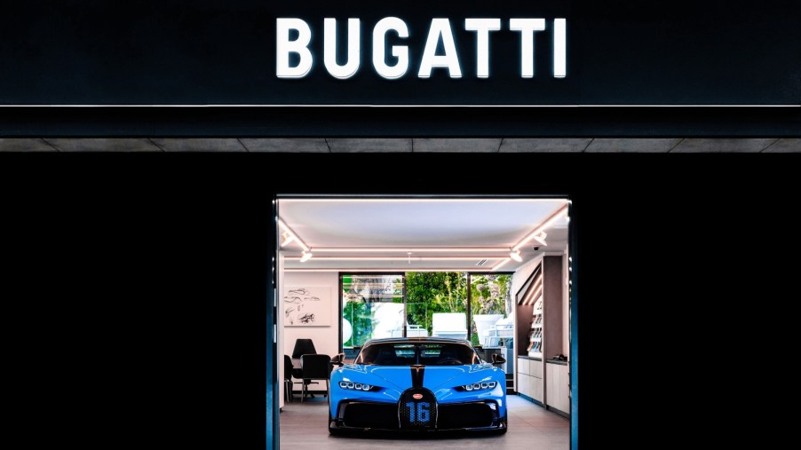 The new Bugatti logo on a building with the Bugatti Chiron Pur Sport under it