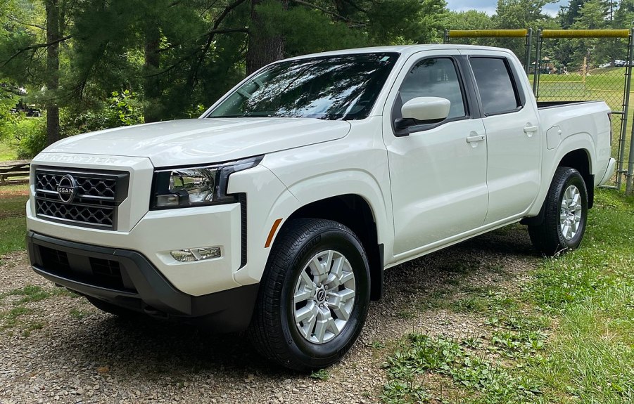 A white 2022 Nissan Frontier S sits in a field.