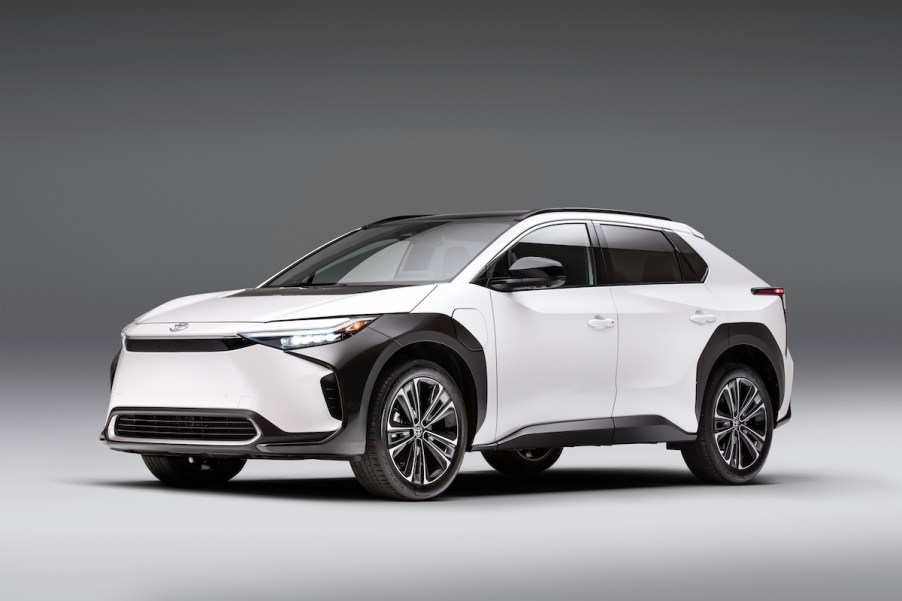 A white 2023 Toyota bZ4X parked in a white and black room.